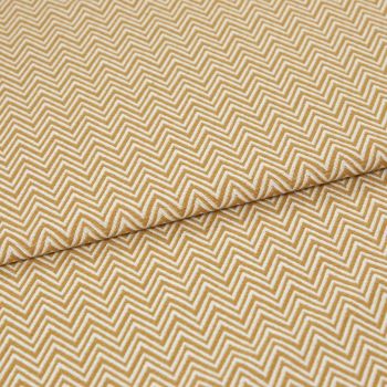 Mustard-and-white chevron fabric, tightly woven, folded across the frame; pattern repeats in narrow zigzags. Close-up view showing textured weave and soft, even lighting on a flat surface.