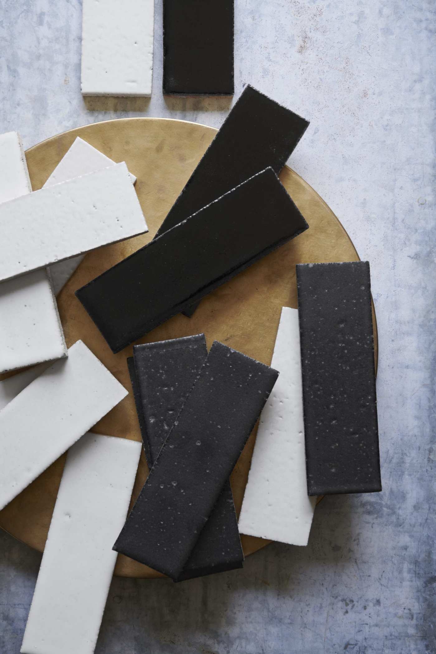 a group of black and white tiles scattered on a wooden board.