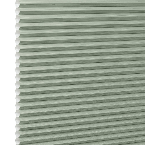 Honeycomb cellular blind with horizontal pleats and white cell edges â€” fully lowered and closed â€” pale sage-green fabric, close-up interior view, evenly lit and diffusing incoming light.