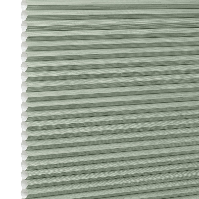 Honeycomb cellular blind with horizontal pleats and white cell edges â€” fully lowered and closed â€” pale sage-green fabric, close-up interior view, evenly lit and diffusing incoming light.