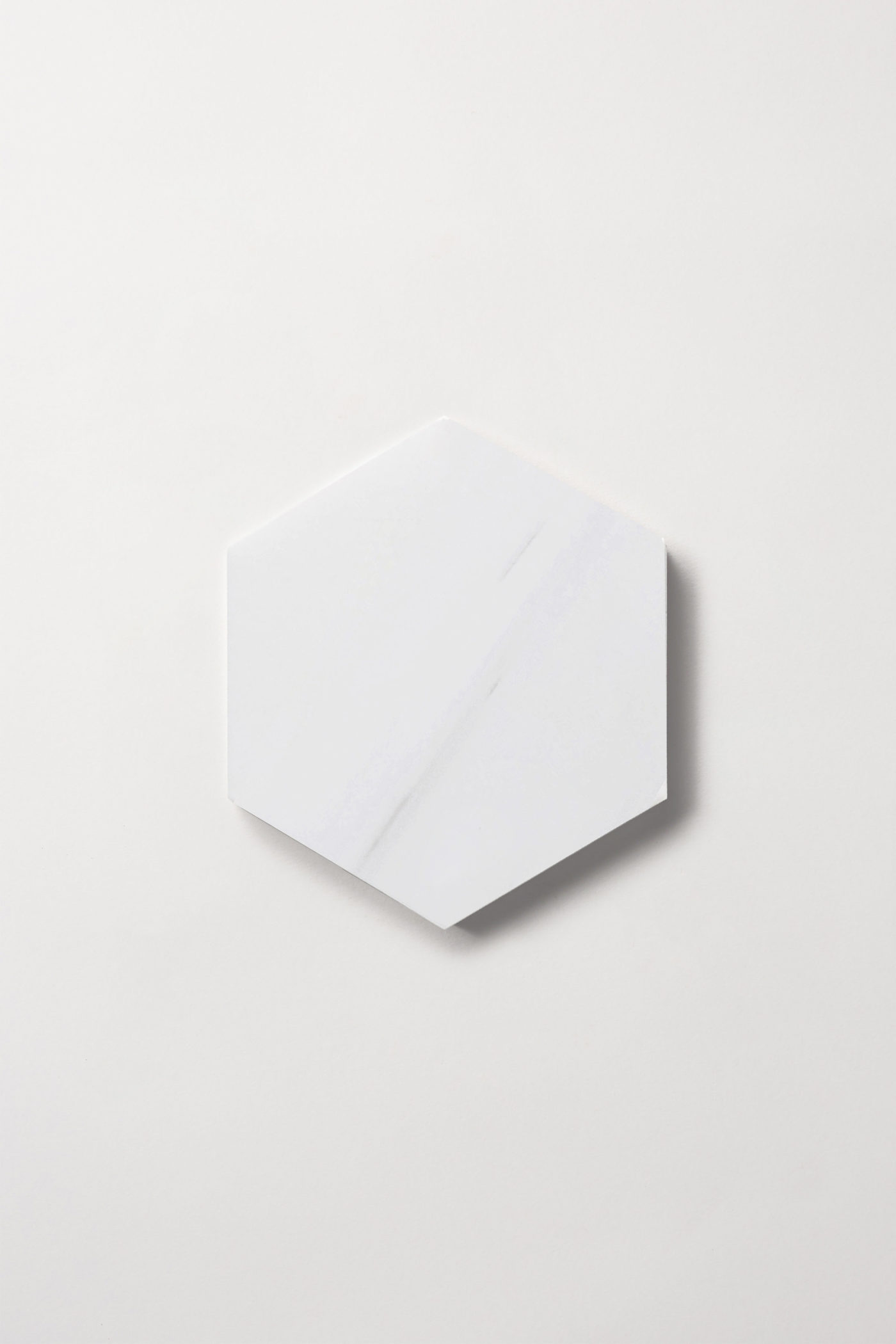 a white hexagonal tile on a white background.