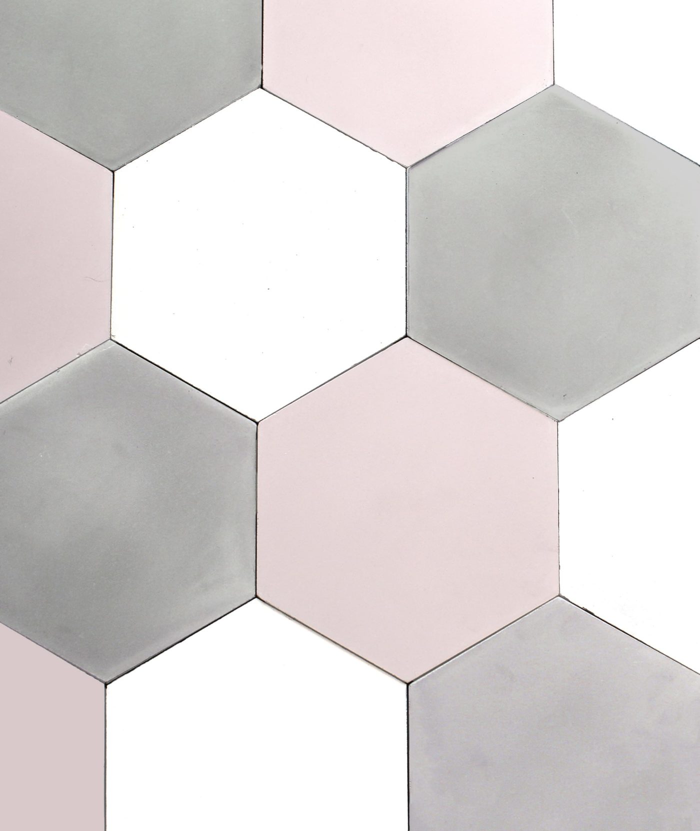 a tiled surface with grey, white, and pink hexagonal tiles.