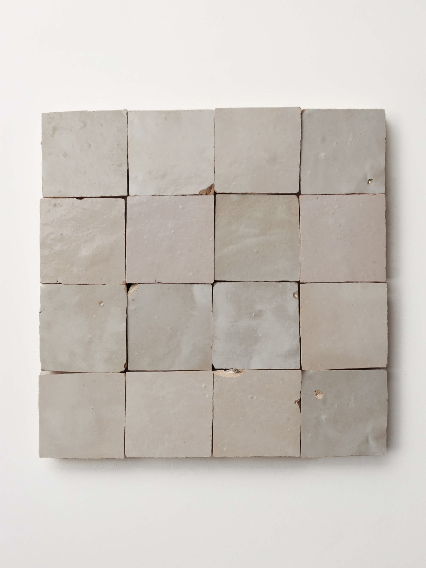 square gray tiles on a white surface.