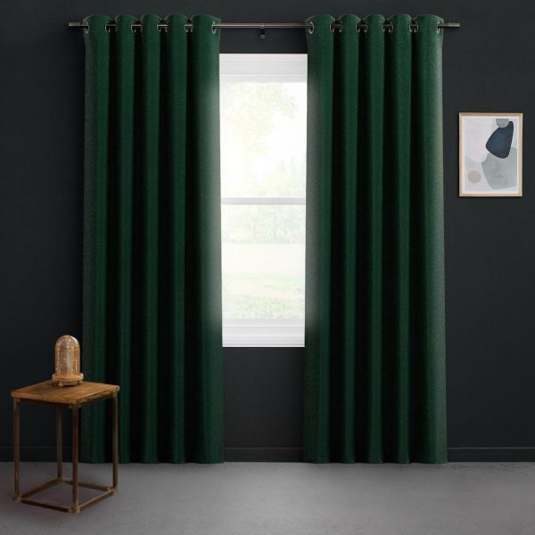 Dark green grommet-top curtains hang on a metal rod, parted to reveal bright daylight through the window; set against dark walls with a wooden side table and abstract framed art.