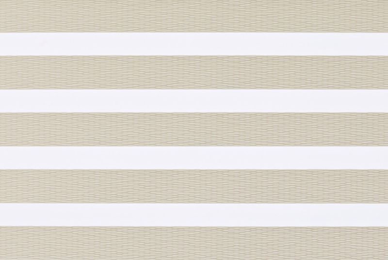 Layered horizontal-striped window blind (zebra style) across a window, alternating opaque white and beige woven sheer bands; closed in a neutral-lit interior, softly diffusing daylight.