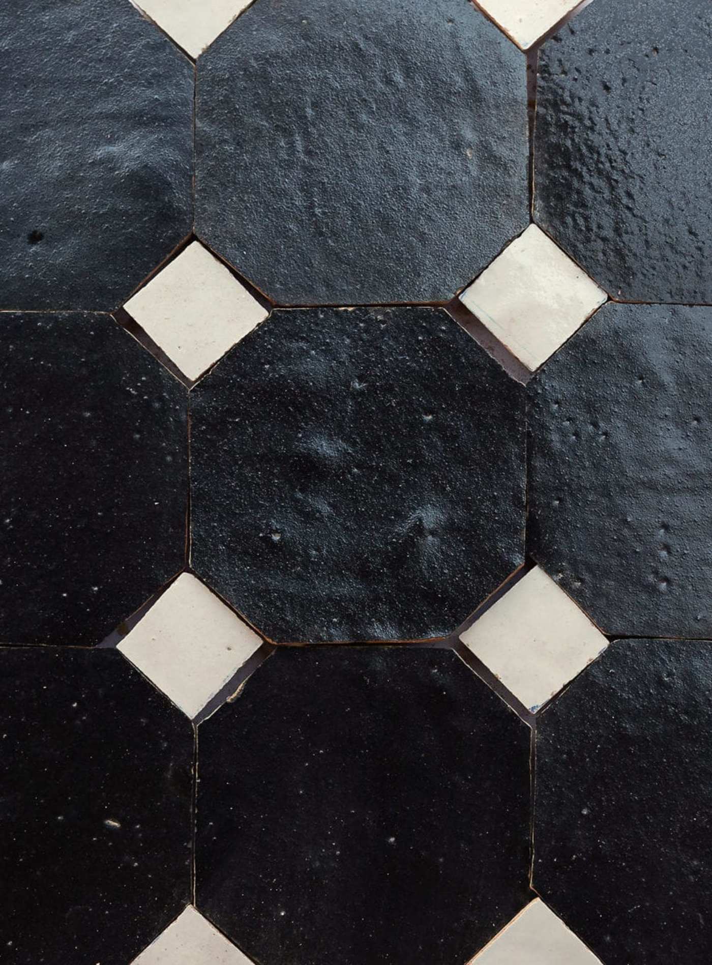 a close up of a black and white tile pattern.