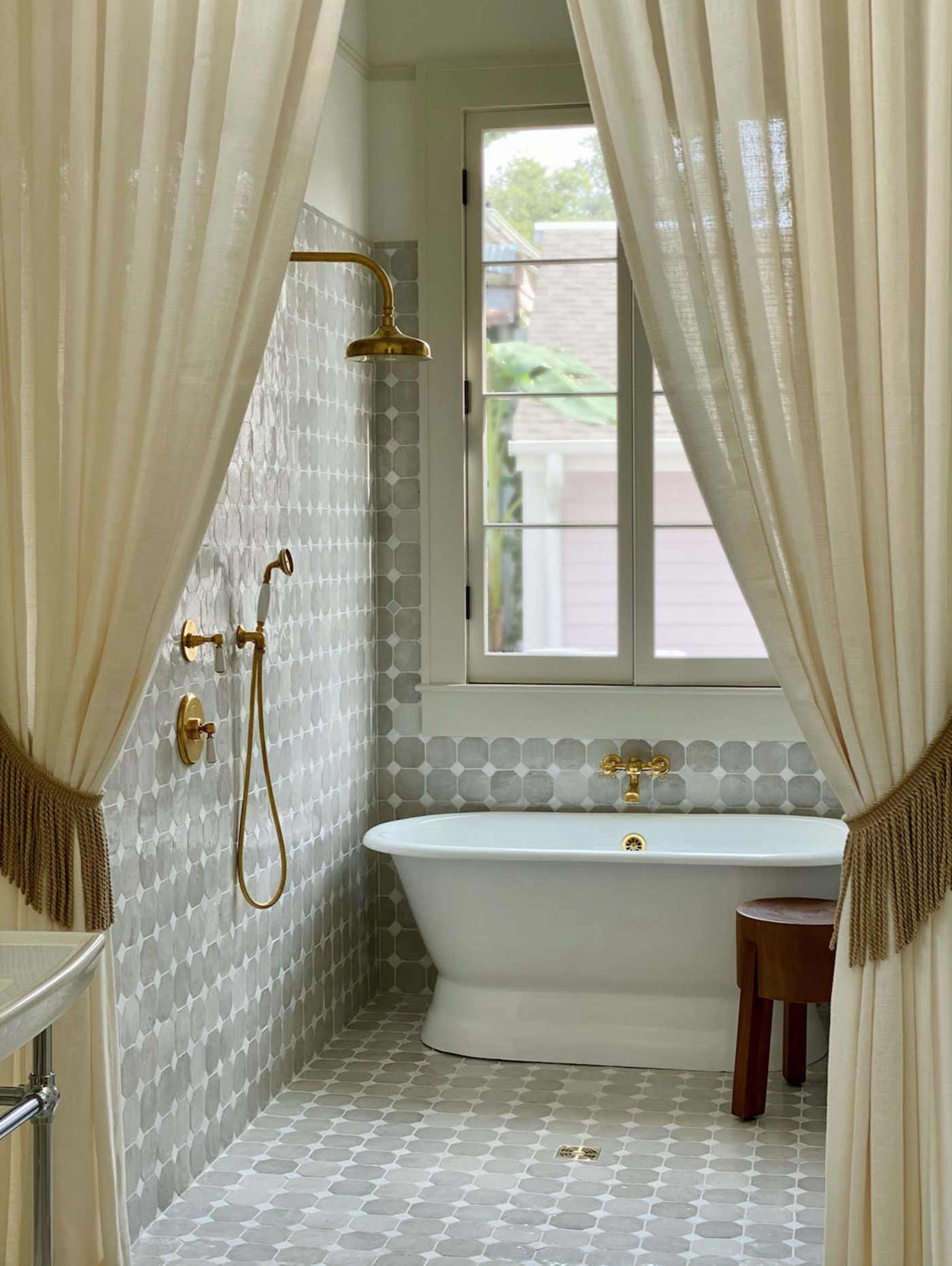 a tiled bathroom with a tub and a shower curtain.