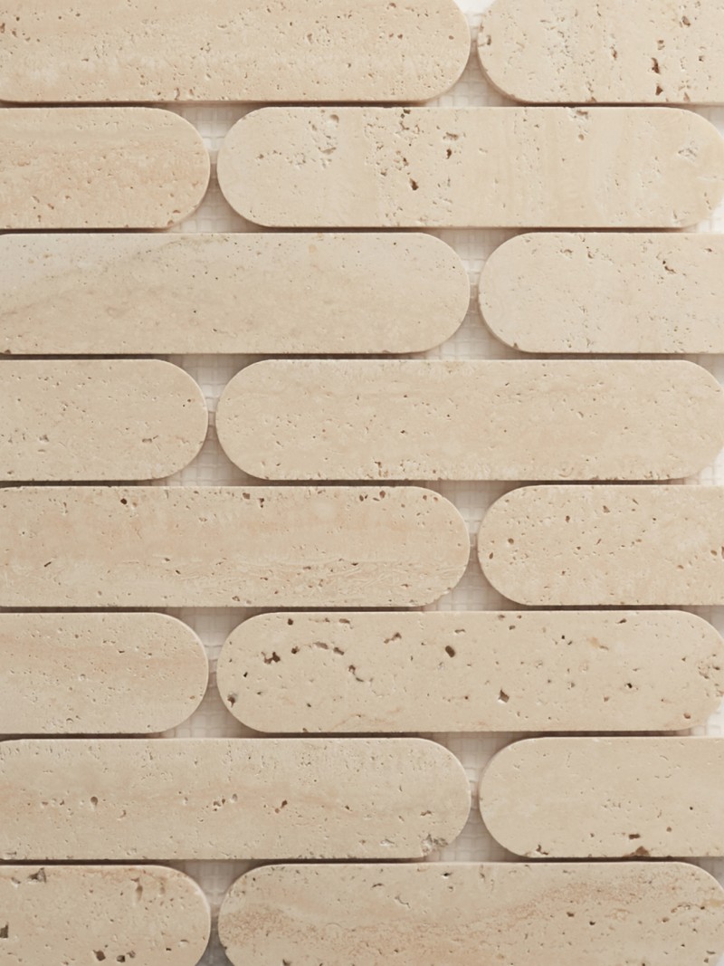 a close up image of a beige travertine tile.