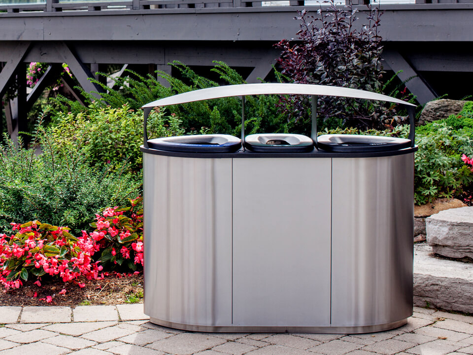 triple stream waste and recycling bin made from high-end stainless steel with an outdoor canopy lid sitting outside at golf course clubhouse