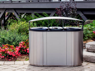 triple stream waste and recycling bin made from high-end stainless steel with an outdoor canopy lid sitting outside at golf course clubhouse