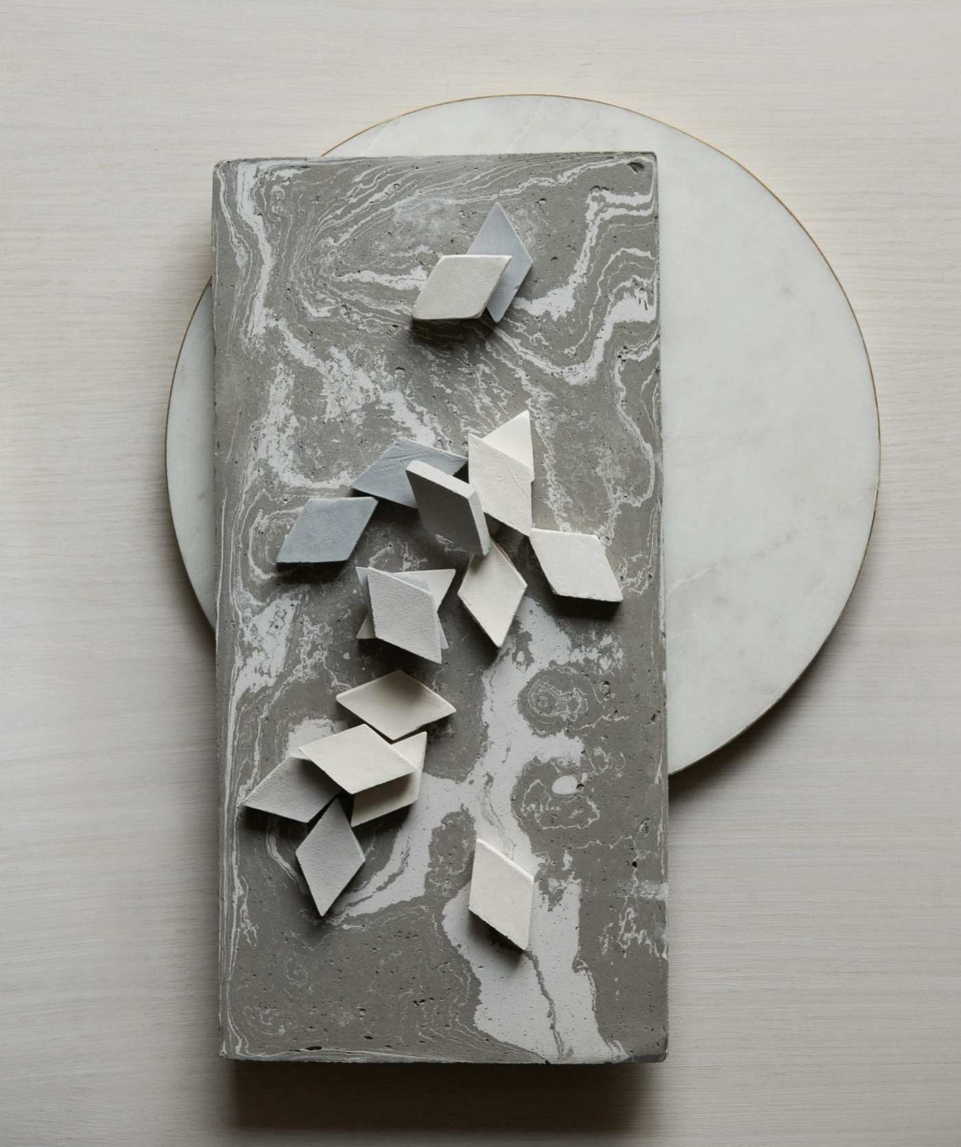 a white and grey rectangle tile on a white plate.