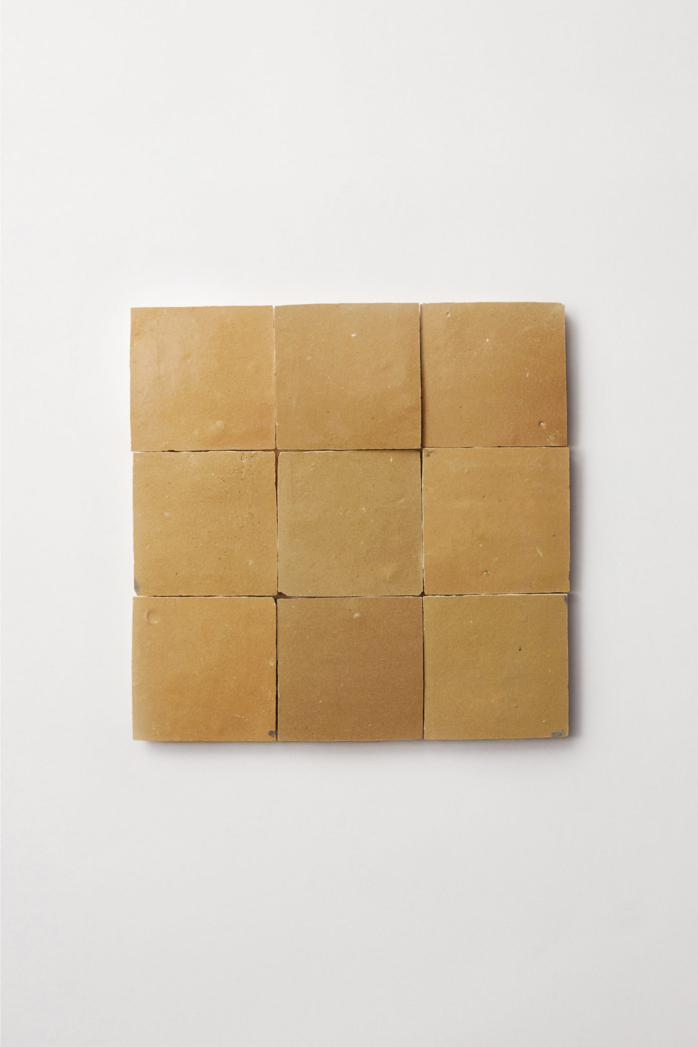 9 squares of yellow tile on a white background.