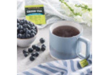 Lifestyle image of a cup Bigelow Green Tea with Blueberry and Acai