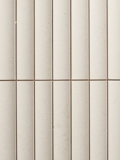 a close up view of a white tiled wall.