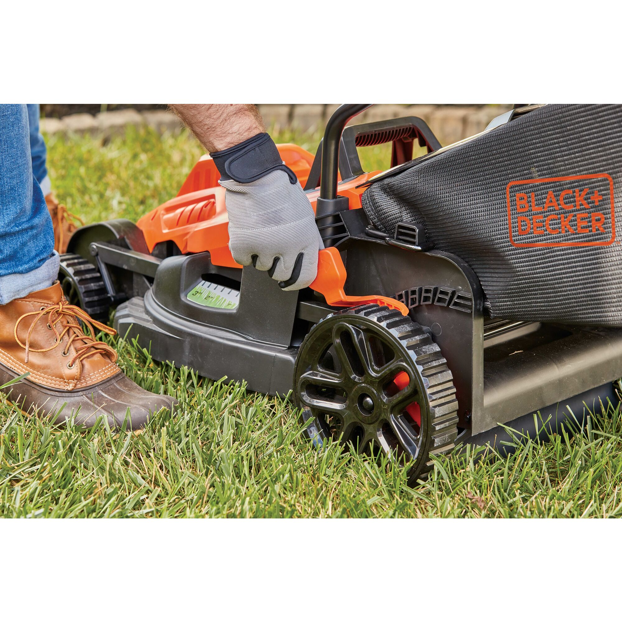 Rugged wheel treads feature of 10 Amp 15 inch electric lawn mower with comfort grip handle.