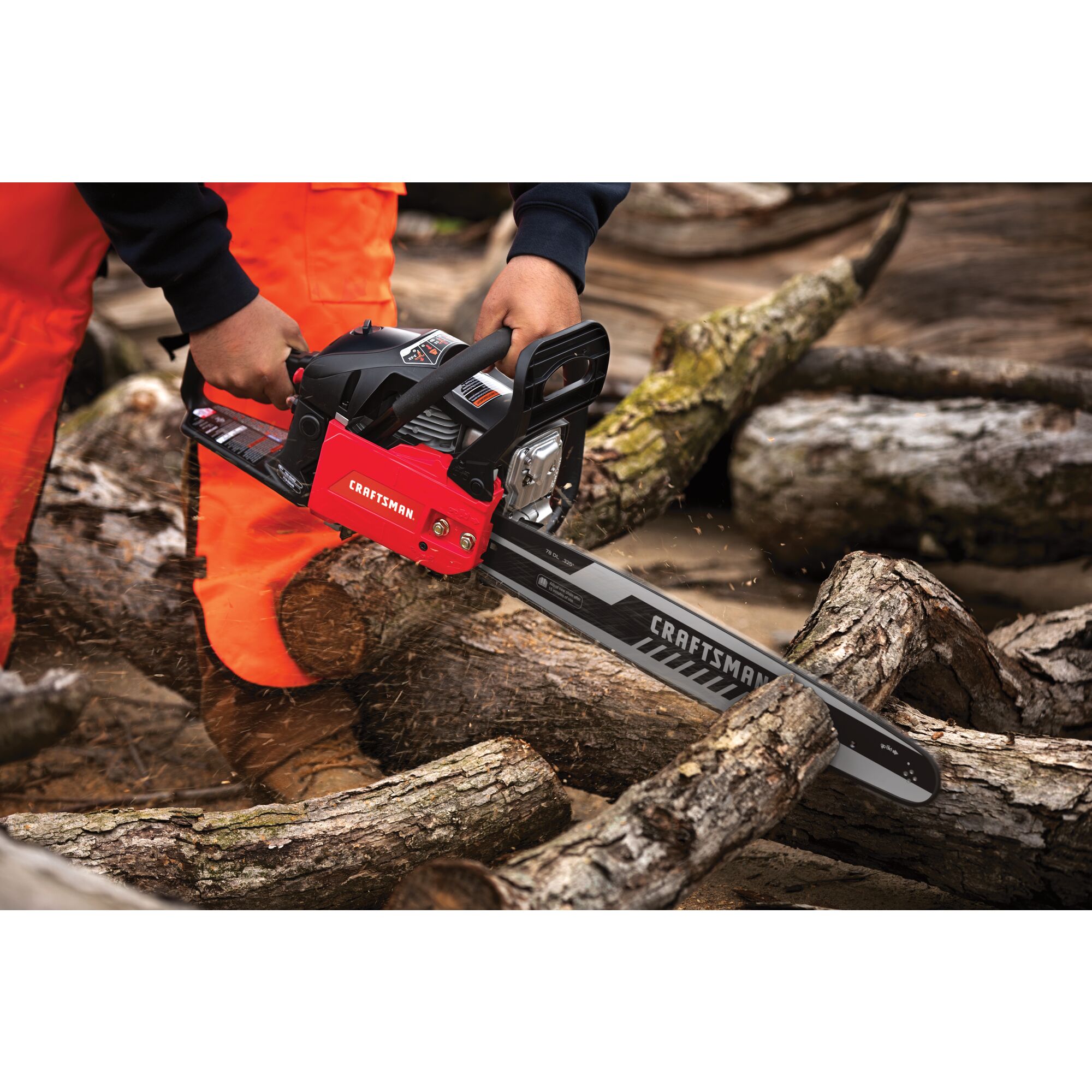 CRAFTSMAN 20-In. 46cc 2-Cycle Chainsaw cutting through wood branches wearing orange pants