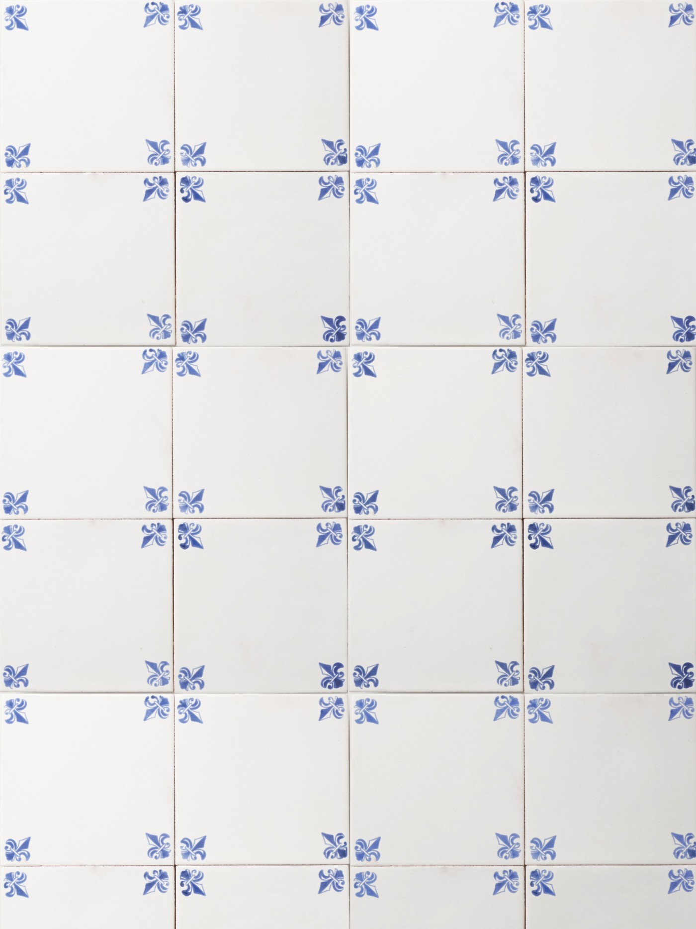 white tiles with hand painted blue designs on the corners.