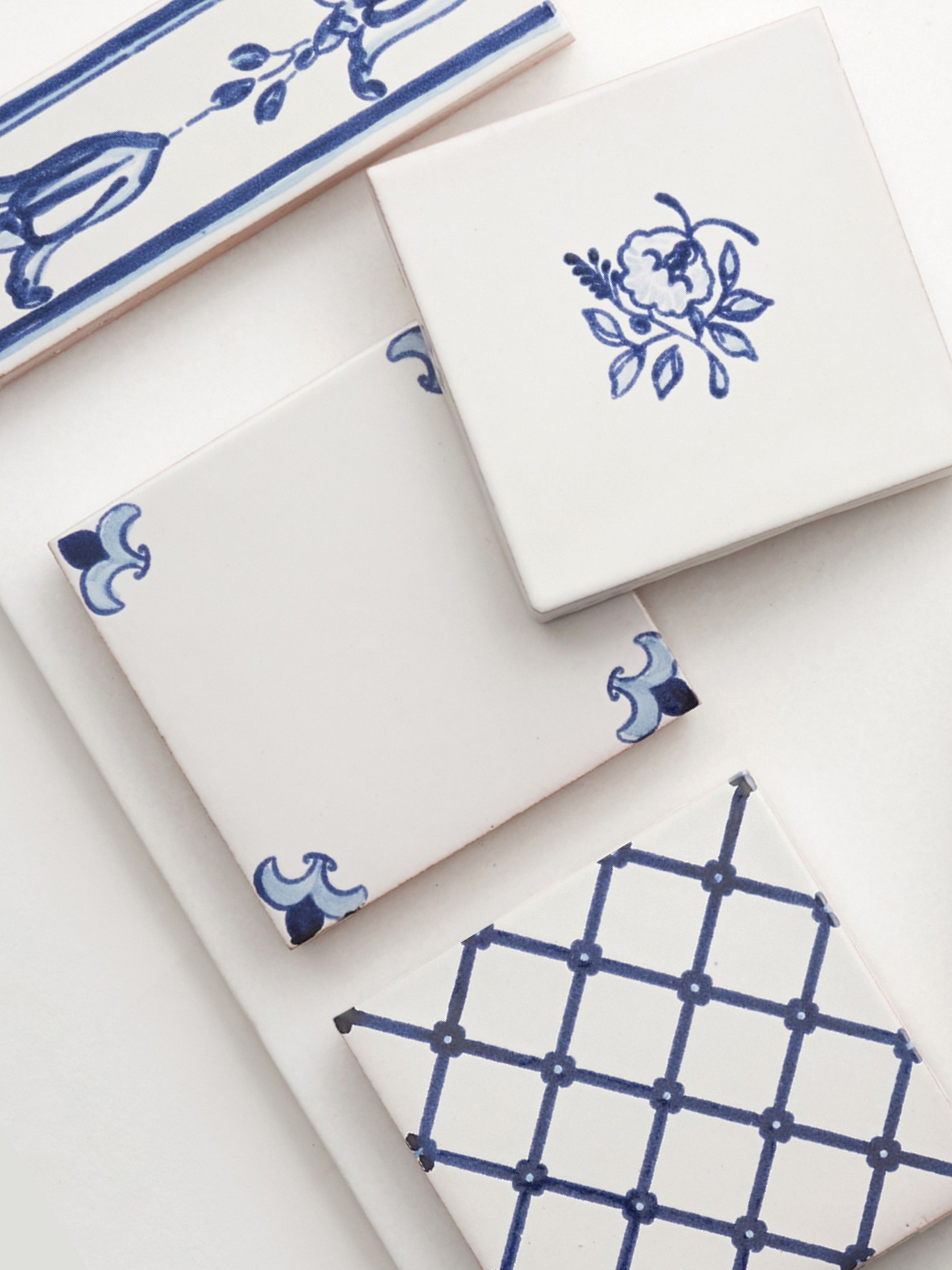 a set of blue and white tiles with designs on them.