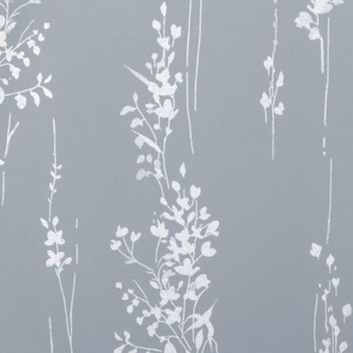 White, hand-drawn vertical floral-vine wallpaper covering a matte slate-blue wall, forming repeated slim columns of leaves and blossoms and creating a subtle vertical rhythm in soft, even light.