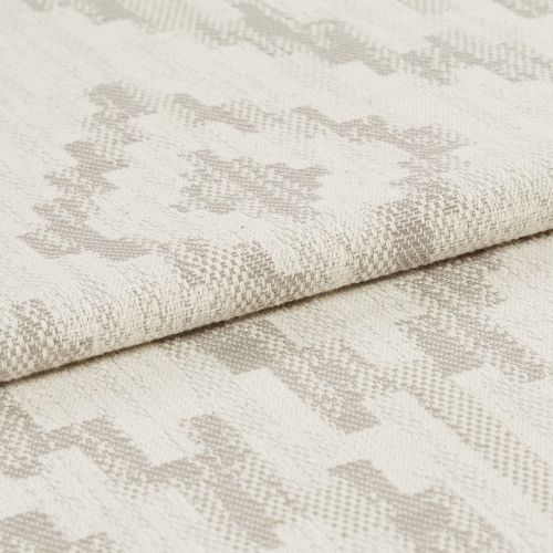 Woven upholstery fabric with light beige geometric motif, folded over once showing textured weave; close-up studio shot with neutral lighting emphasizing fibers and subtle pattern.