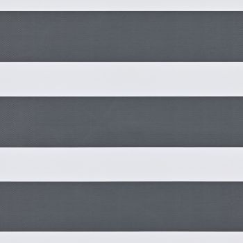 Dual-layer zebra roller blind with wide opaque white bands and narrower textured dark-gray sheer stripes, mounted across a window; aligned to create alternating bands, partially filtering daylight in an interior.