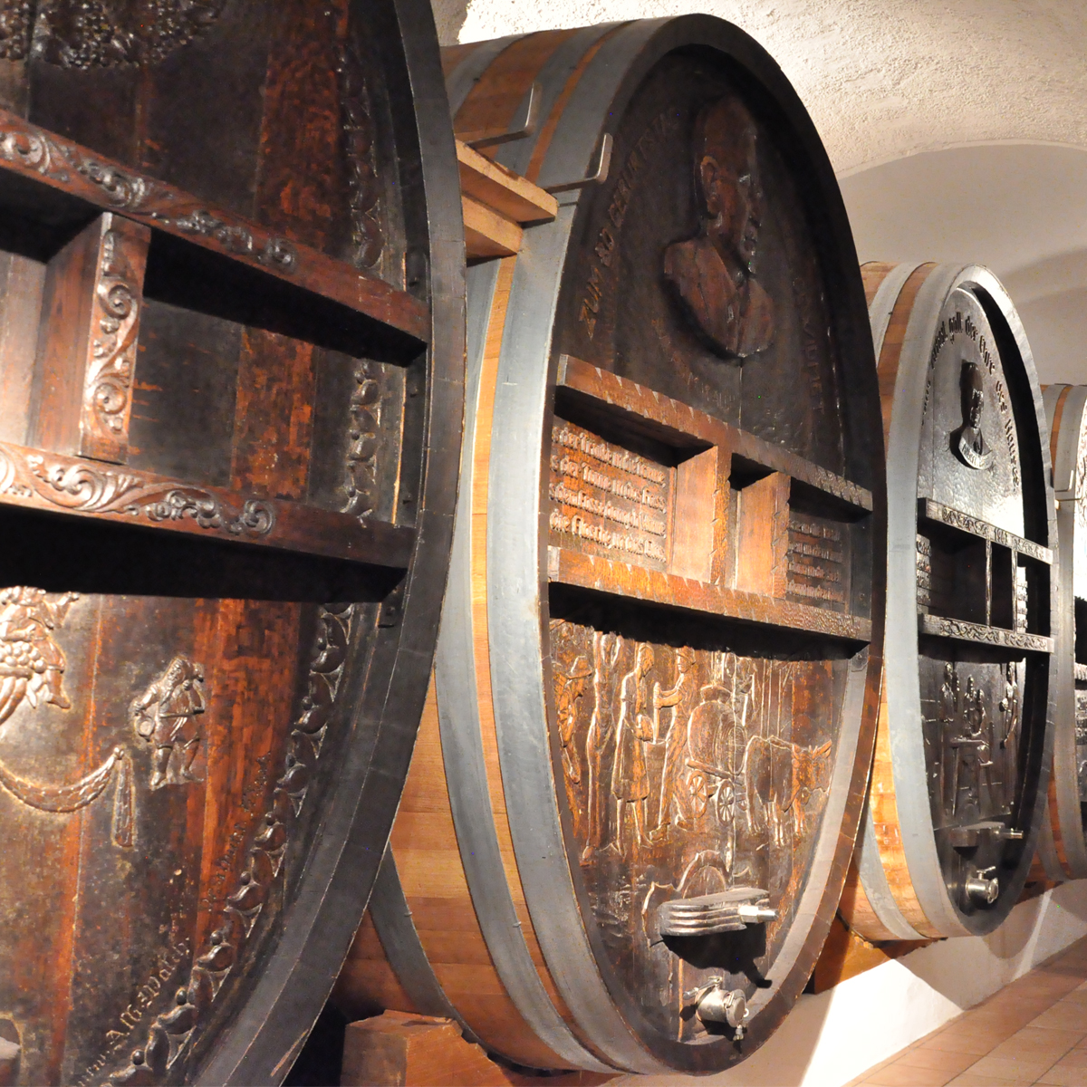 Wood carved barrels in Elena Walch historic cellar