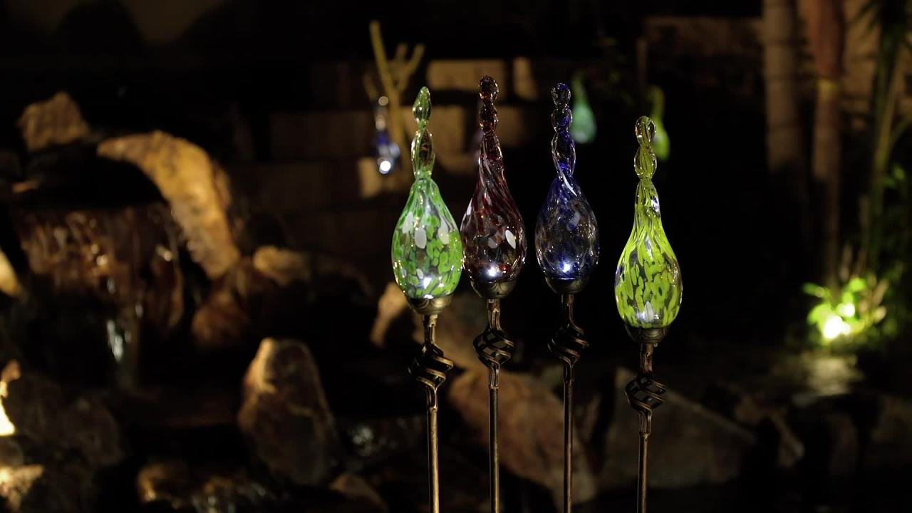 thumbnail video image 2 of Exhart  Solar Pearlized Hand Blown Glass Twisted Flame Garden Stake with Metal Finial Detail, 36 Inch Red, 2 of 7