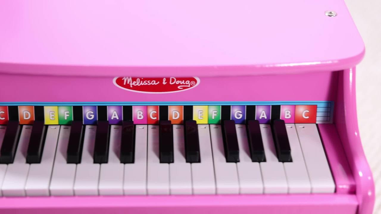 thumbnail video image 2 of Melissa & Doug Learn-to-Play Pink Piano With 25 Keys and Color-Coded Songbook, 2 of 10