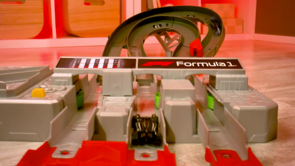 thumbnail video image 2 of Hot Wheels Race Formula 1 Grand Prix Circuit Track Set with 3 1:64 Scale Die-Cast Toy Cars, 2 of 7