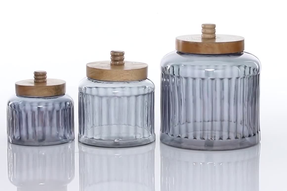 thumbnail video image 2 of DecMode 8", 6", 5"H Gray Glass Decorative Jars with Wood Lids, 3-Pieces, 2 of 11