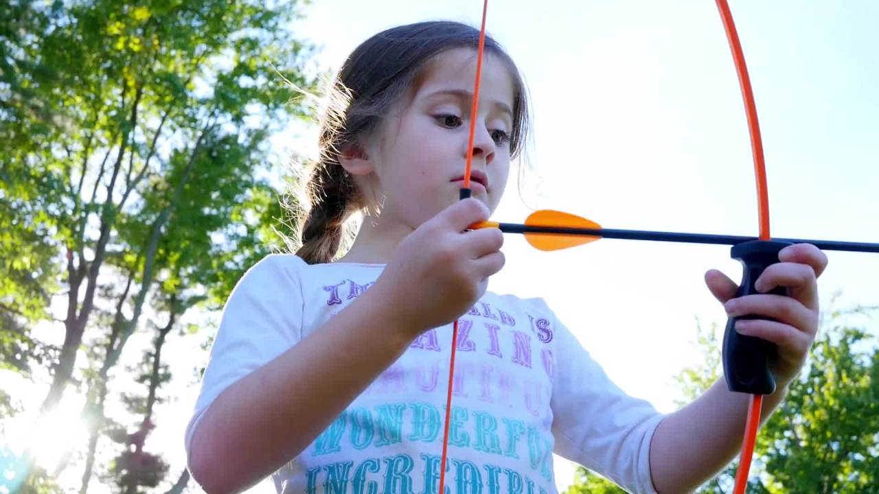thumbnail video image 2 of Bear Archery 1st Shot Youth Bow Set Includes Arrows, Armguard, and Arrow Quiver Recommended for Ages 4 to 7 –&nbsp;Flo Orange, 2 of 7