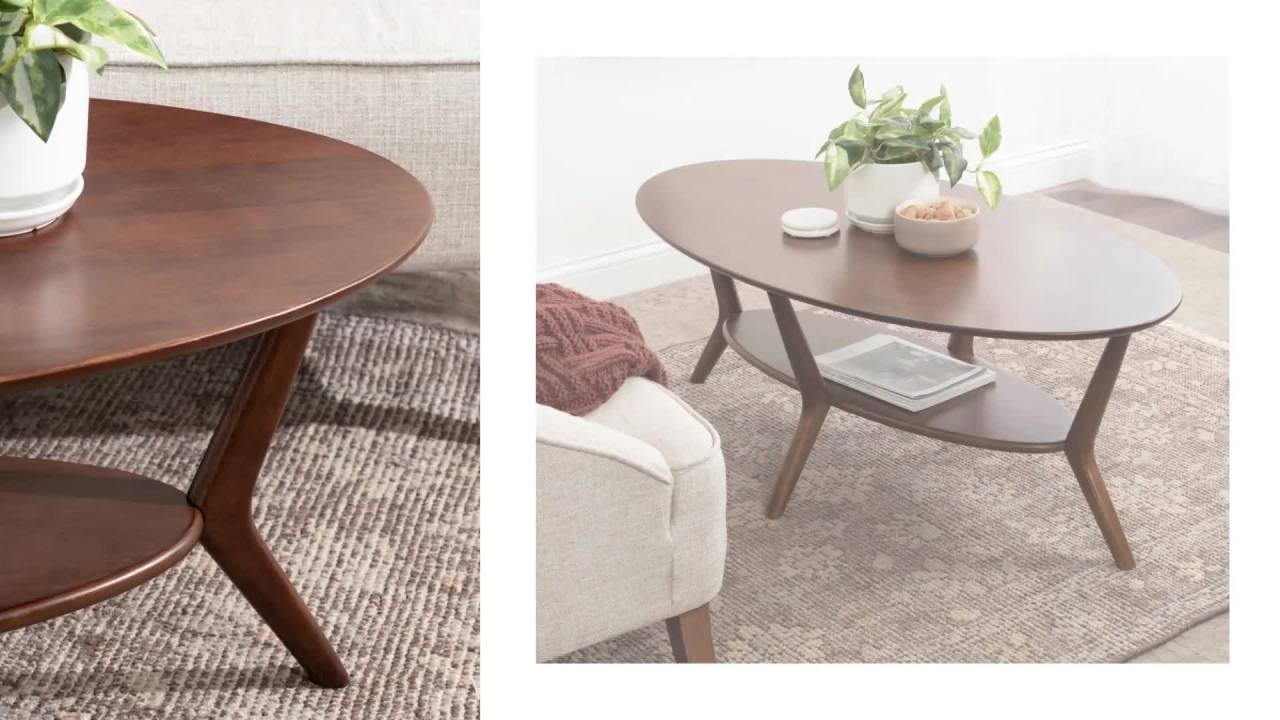 thumbnail video image 2 of Kate and Laurel Nylah Oval Wooden Coffee Table, 48 x 26 x 18, Black, Modern Tiered Living Room Table with Solid Wood Construction and Sculptured Dowel Legs, 2 of 8