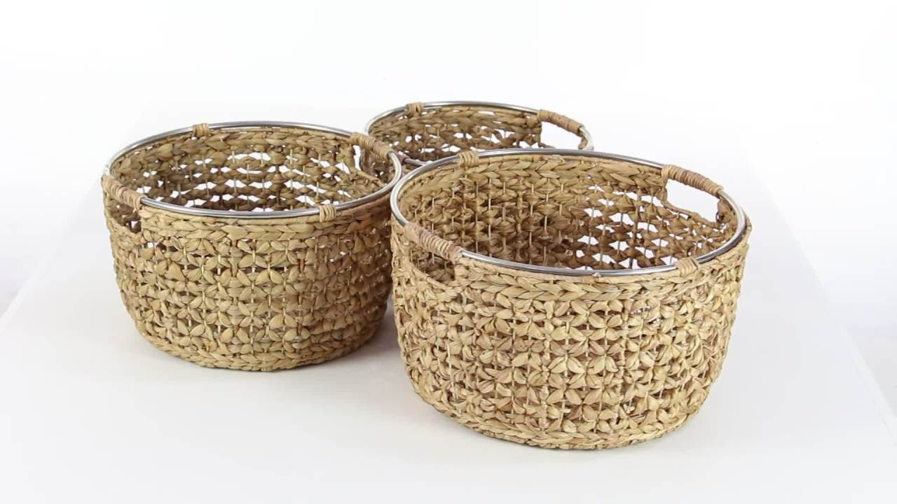 thumbnail video image 2 of DecMode Tan, Wicker Natural Dried Plant, Coastal Serene Basket Set of 3 15", 17", 19"W, featuring Rattan Weave Design and Metal Ring Handle Accents, for Throw Blankets, Pillows, Living Room Storage, 2 of 11