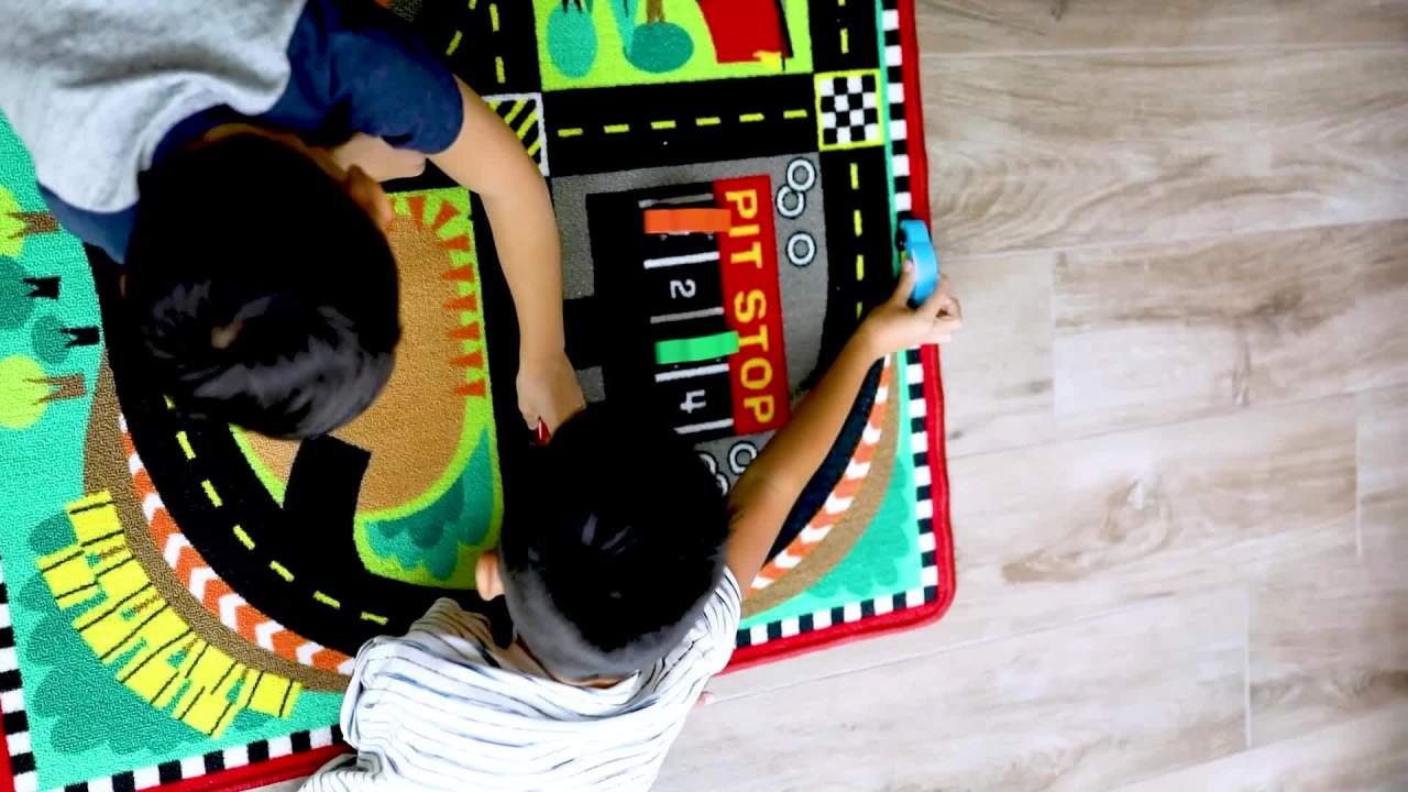 thumbnail video image 2 of Melissa & Doug Round the Speedway Race Track Rug With 4 Race Cars (39 x 36 inches), 2 of 10