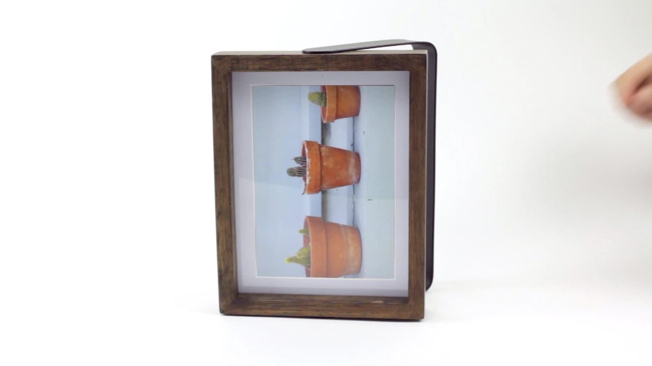 thumbnail video image 2 of Umbra Axis Photo Frame, Pivoting Metal Handle and Wood Frame, 2 of 3