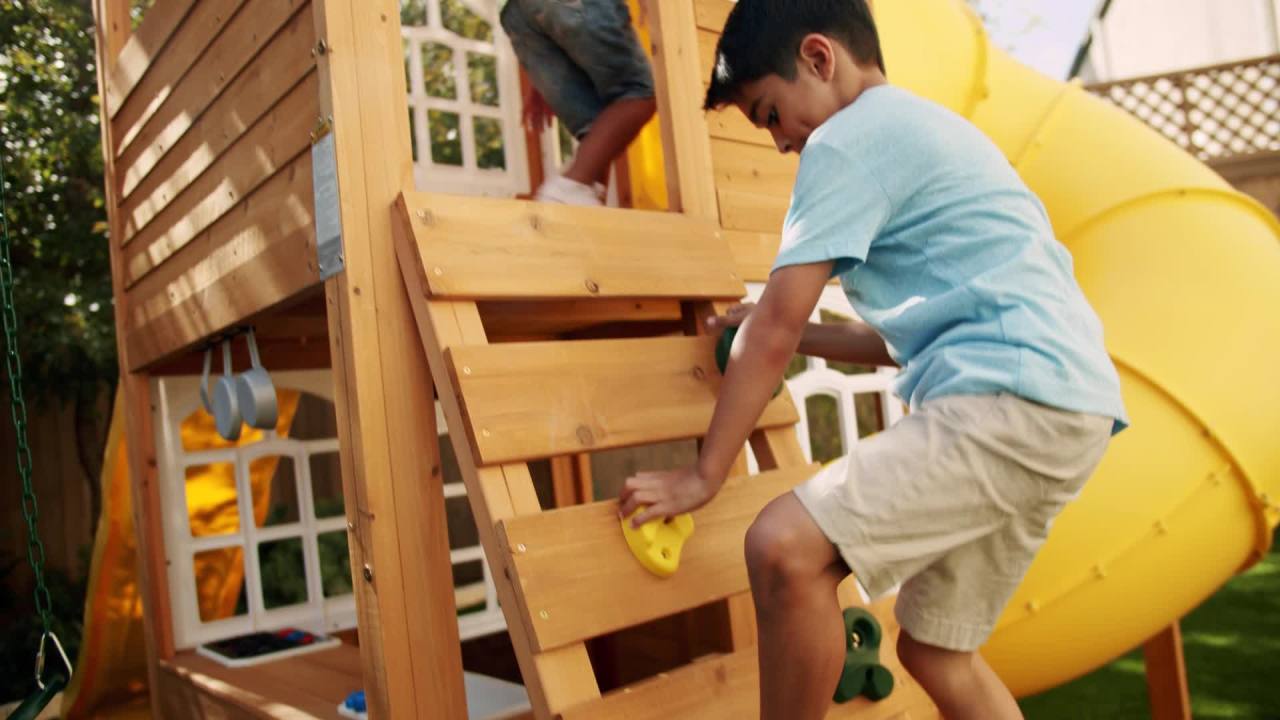 thumbnail video image 2 of KidKraft Castlewood Wooden Swing Set / Playset with Clubhouse, Mailbox, Slide and Play Kitchen, 2 of 2