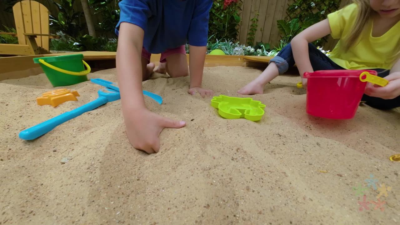 thumbnail video image 2 of KidKraft Wooden Backyard Sandbox with Built-in Corner Seating and Mesh Cover, Honey, 2 of 9