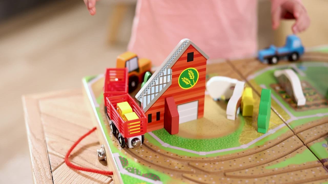 thumbnail video image 3 of Melissa & Doug 17-Piece Wooden Take-Along Tabletop Farm, 4 Farm Vehicles, Wood Play Pieces, Barn, Grain House, Model Train Sets, 3 of 11