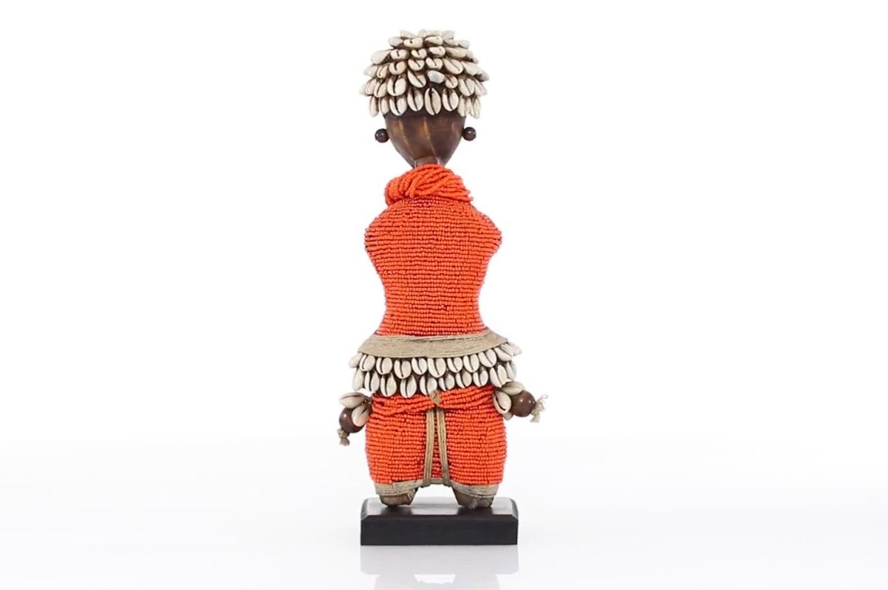 thumbnail video image 2 of DecMode Small Hand-Crafted Pine Wood, Cowrie Shells, Orange Beads & Kente Cloth African Woman Namji Doll, Orange, 2 of 9