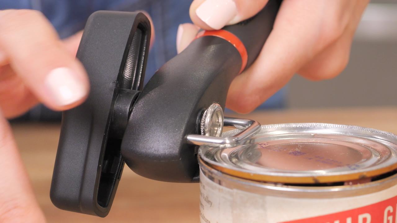 thumbnail video image 3 of Farberware Soft Grips Safety Can Opener in Black with Red Accents, 3 of 15